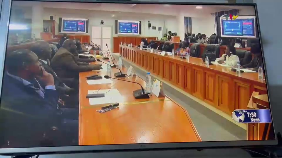 CRTV 7:30 News. The workshop hall, with simulations on the screens along the wall.